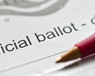 Image of an absentee ballot and a pen 